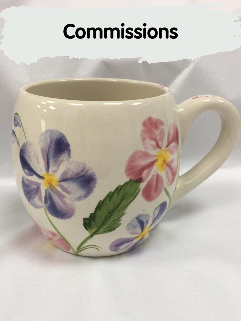 A decorative coffee mug featuring a floral design, showcasing vibrant flowers painted on its surface. Pot painting in Hillsborough